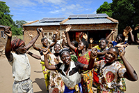 Women celebrating arrival of a 'solar kiosk' centre in their isolated village in Machinga district, Malawi - part of the Scottish Government's Climate Challenge Programme Malawi [CCPM] project