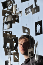 Artist Jonathan Lynch with part of his exhibition of acquired photographs