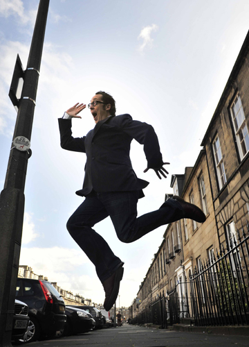 Bringing sunshine to Edinburgh: Bob Golding as Eric Morecambe, spotted skipping along Edinburgh's Albany Street