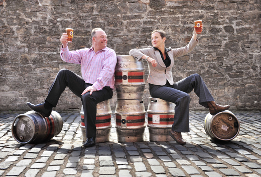Edinburgh Festival Fringe chief executive Kath Mainland raises a pint with Caledonian Brewery managing director Stephen Crawley to celebrate a 3-year sponsorship of the Fringe