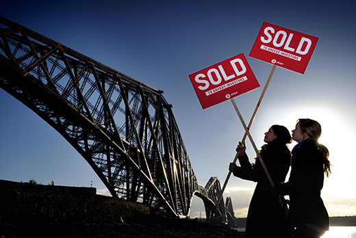Oxfam Scotland demonstrators erect 'Sold' signs at the Forth Bridge