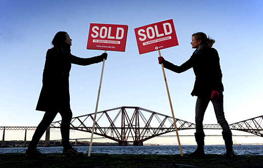 Oxfam Scotland demonstrators erect 'Sold' signs at the Forth Bridge