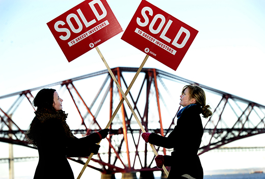 Oxfam Scotland demonstrators erect 'Sold' signs at the Forth Bridge