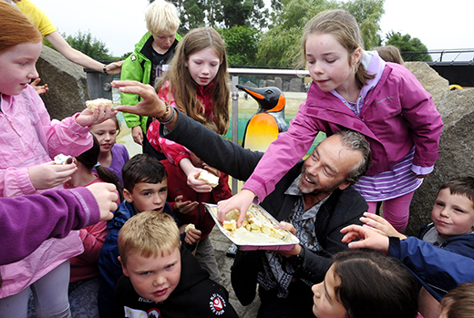 John Hannah hands out celebratory cakes to youngsters